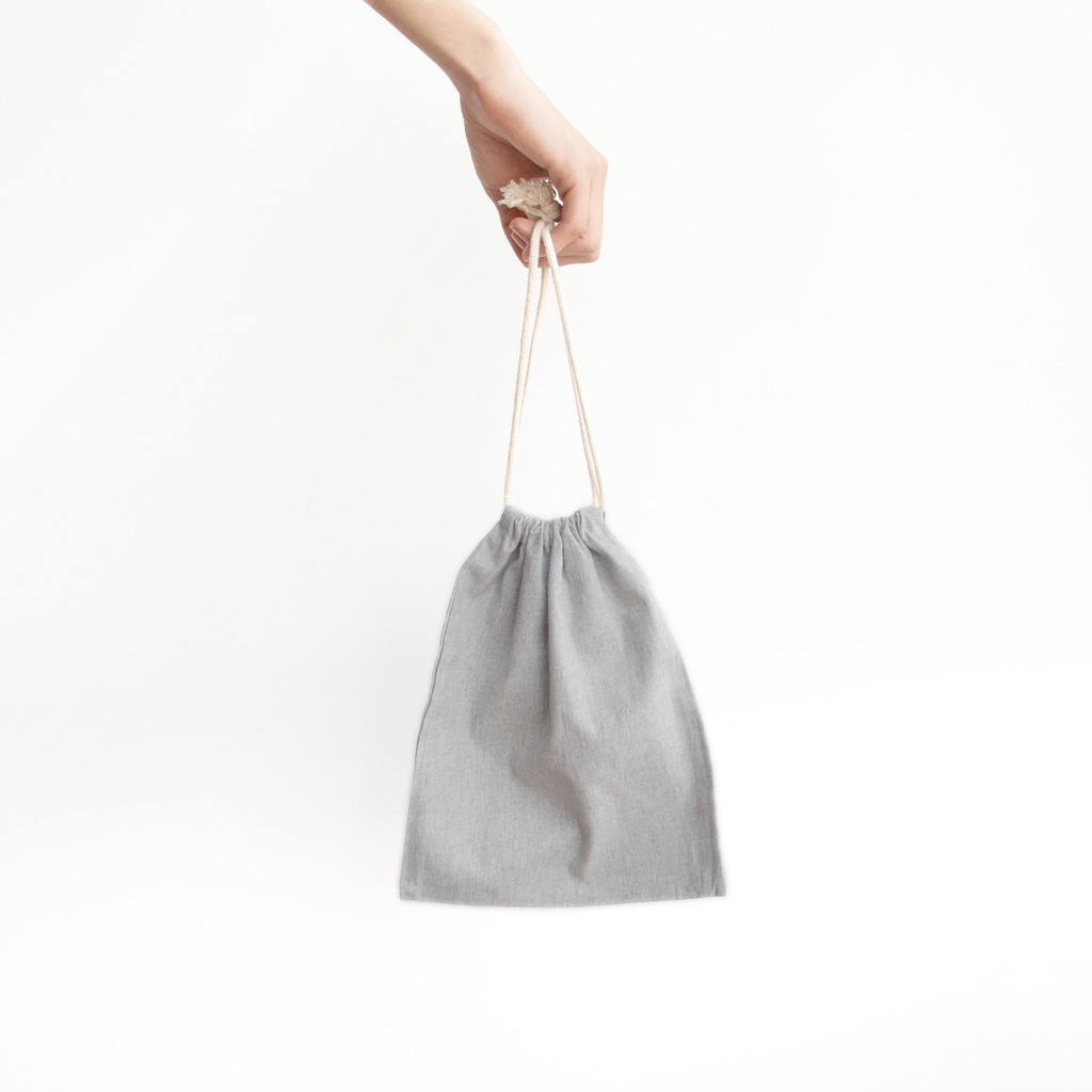 ごろごろにゃんすけのどんぐりぼうや Mini Drawstring Bag is large enough to hold a book or notebook