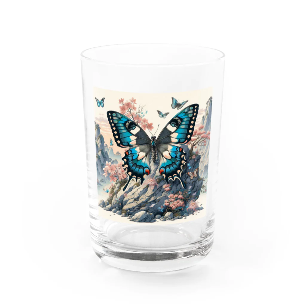 momonekokoの岩場の上で華やかに舞う蝶と咲き誇る花々 Water Glass :front