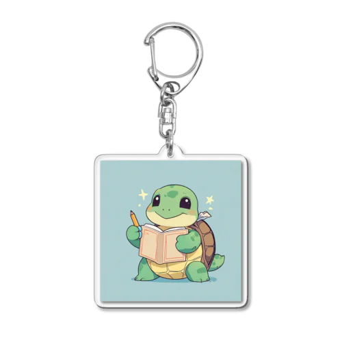 おもちゃの本を持ったかわいいカメ Acrylic Key Chain