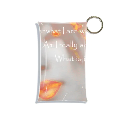  A woman looking down ~ with text Mini Clear Multipurpose Case